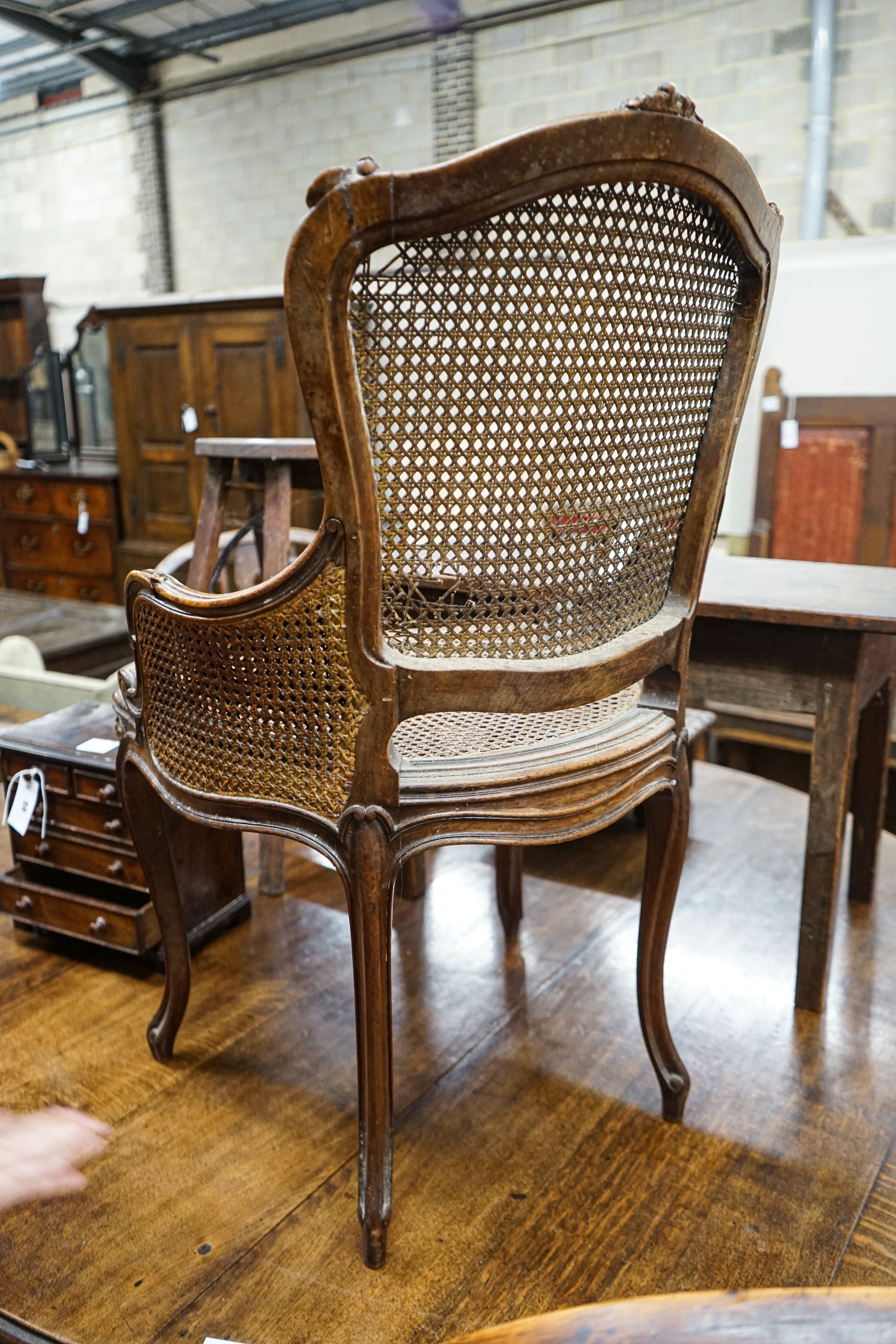 A 19th century French carved and caned walnut salon chair, width 52cm, depth 46cm, height 87cm